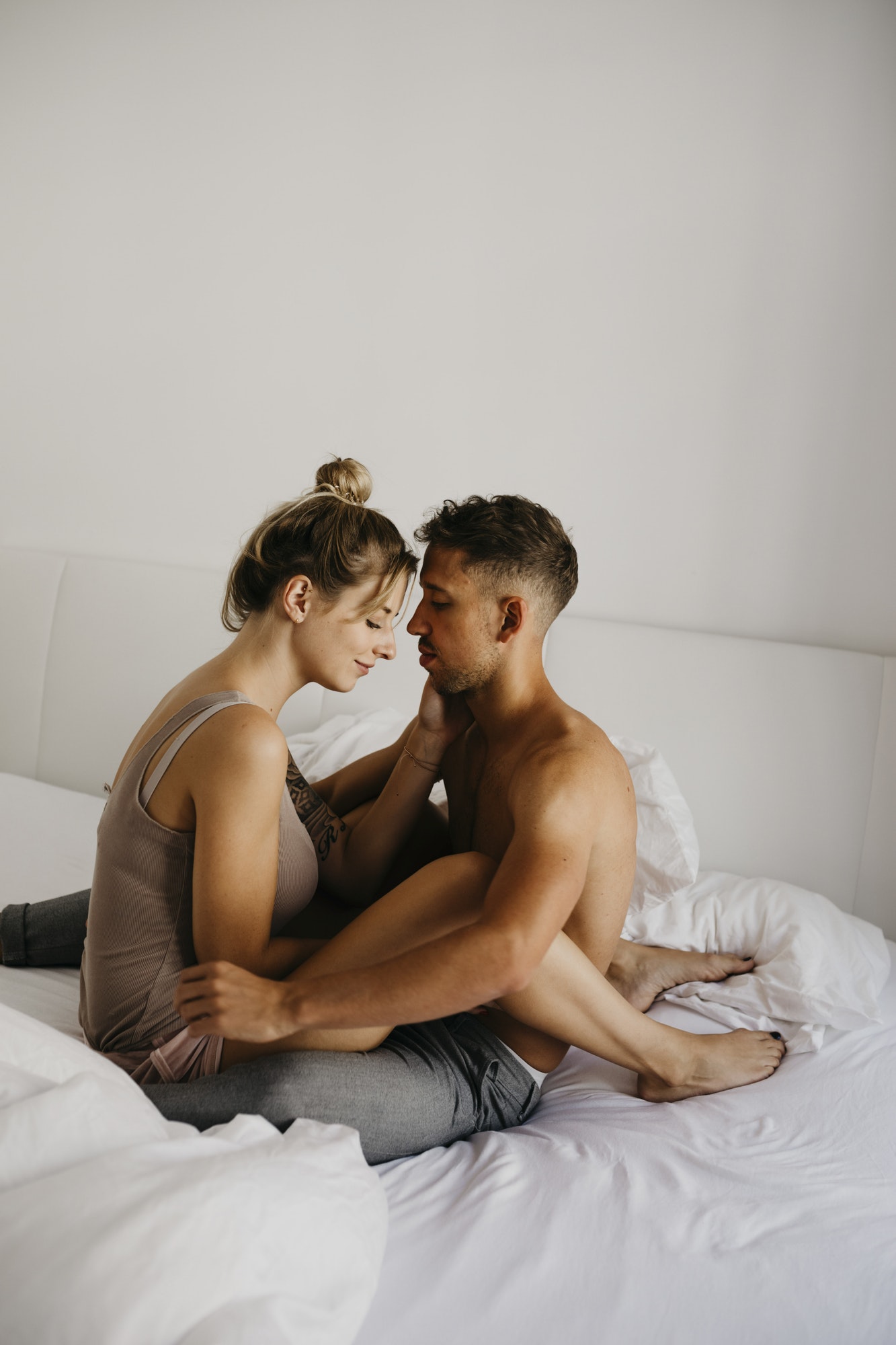 Romantic young couple sitting on bed